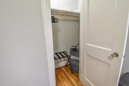 a room with a closet with a bed and a door at Sweet Home Alabama Sleeps 8 in Tuscaloosa