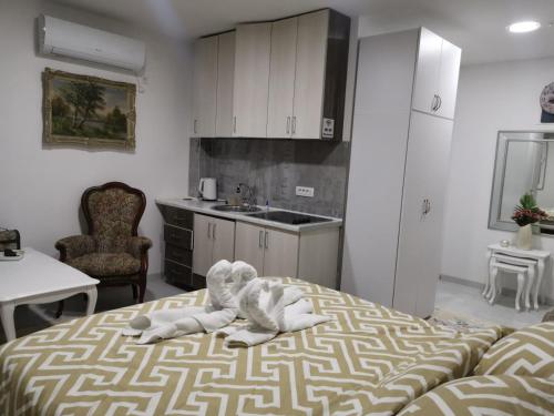 a room with a bed with a stuffed animal on it at IN Apartments AirPort in Podgorica