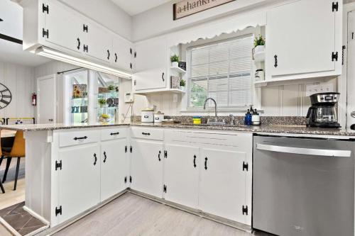 a kitchen with white cabinets and stainless steel appliances at The Ranch 4-Bedrooms Large Yard & Patio in Mobile