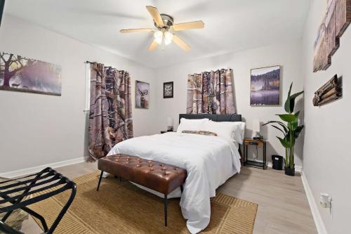 a bedroom with a bed and a ceiling fan at The Ranch 4-Bedrooms Large Yard & Patio in Mobile