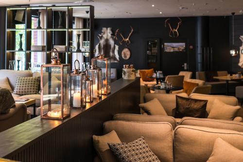 a lobby with couches and a bar with candles at Lapland Hotels Tampere in Tampere