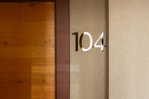 a wooden door with the number on it at Hotel Ma Belle in Pristina