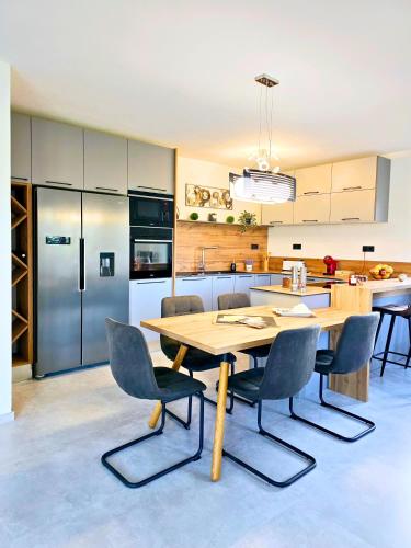a kitchen with a wooden table and chairs at Ferienhaus Biograci in Široki Brijeg