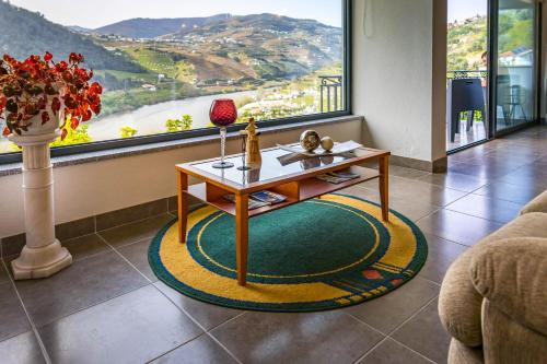 a living room with a coffee table in front of a window at Fraga Douro House, Douro Valley in Resende