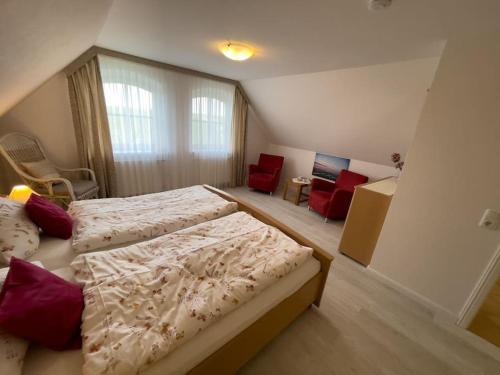 a bedroom with two beds and a living room at Ferienwohnung im Schafhaus in Wangerland