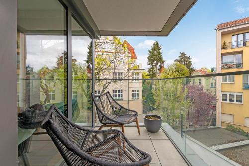 a balcony with two benches and a view of a city at Monte Cassino Apartments by Blue Mandarin in Sopot