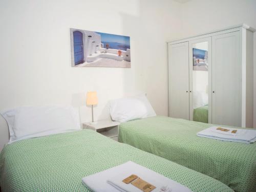 a bedroom with two beds and a mirror at Affittacamere di Andrea Bertolino Argelato in Argelato