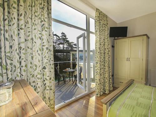 a living room with a large window and a balcony at Waterside - Luxury Menai Bridge Holiday Home - 4 Bed 4 Bath in Menai Bridge