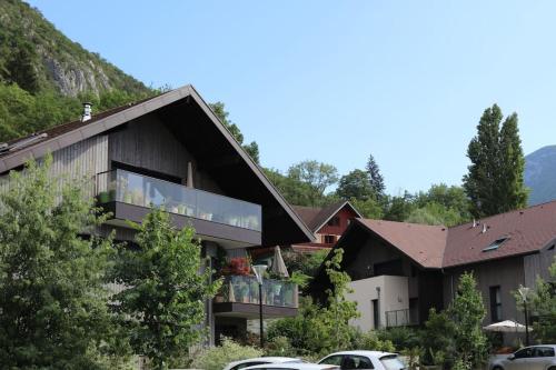 a house with a large window on the side of it at T3, à 5 min à pied du lac Annecy in Duingt