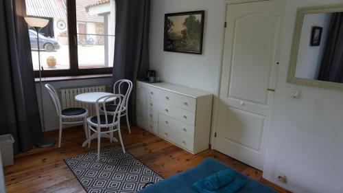 a bedroom with a desk and a table and chairs at Pensjonat Kowalski in Łubowo