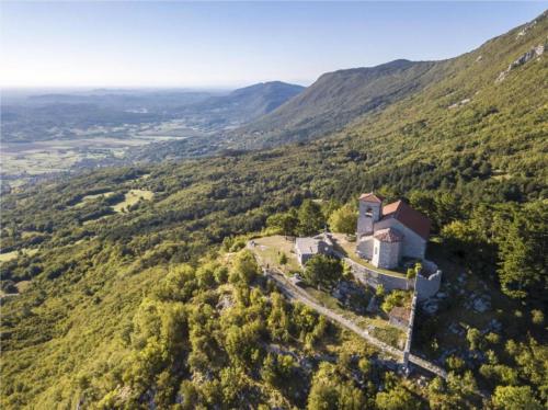 an aerial view of a building on a mountain at Farm Stay Malovščevo in Vitovlje