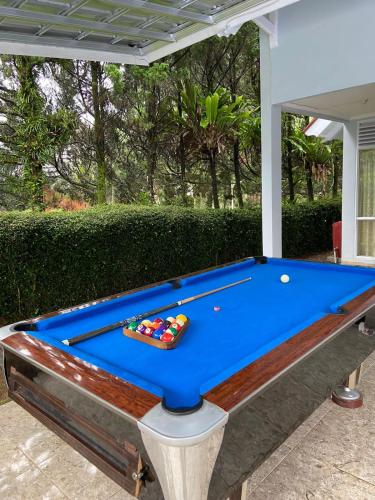 a pool table sitting on top of a patio at Villa Nesa Puncak Cipanas in Cipanas