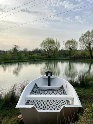 a boat sitting on the side of a river at Coeur Nature in Arsimont