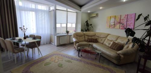 a living room with a couch and a table at Apartment.md in Chişinău
