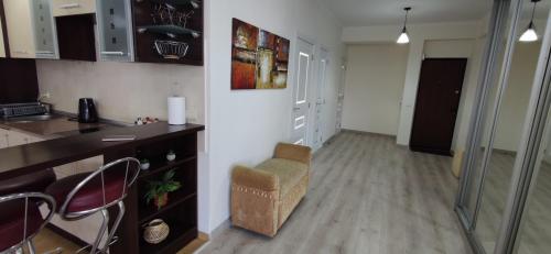 a kitchen with a counter and a chair in a room at Apartment.md in Chişinău