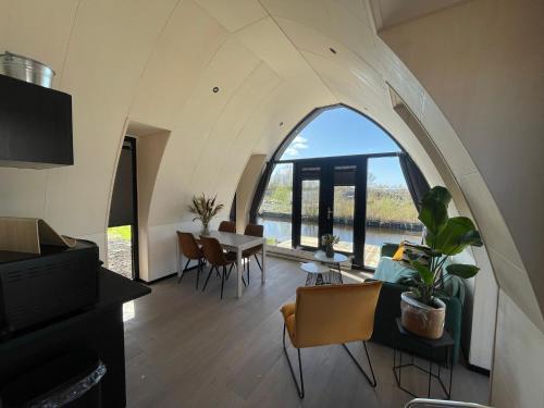 a living room with an arched window in a house at GreenFloat Boskoop #2 in Boskoop