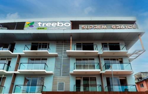 a building with a sign on the top of it at Treebo Trend Supreme Grande in Calangute