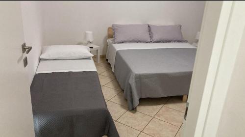Postel nebo postele na pokoji v ubytování Alemà casa vacanze