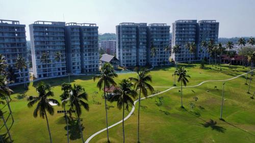 a park with palm trees in front of tall buildings at Golfers' Paradise Kahathuduwa in Gonapola