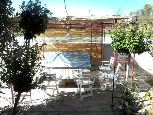 a patio with a group of chairs and a building at Villa spacieuse à Cannes-et-Clairan avec piscine privée in Cannes-et-Clairan