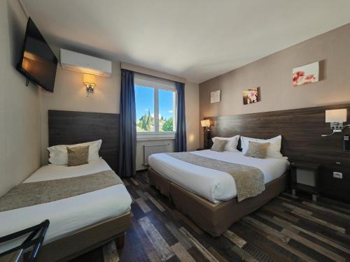 Katil atau katil-katil dalam bilik di Hôtel La Rotonde