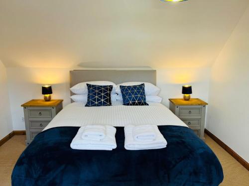 a bedroom with a large bed with two night stands at Avoca House in Fort William