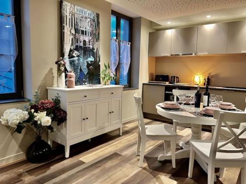 a kitchen and dining room with a table and chairs at Antica Stazione in Guebwiller