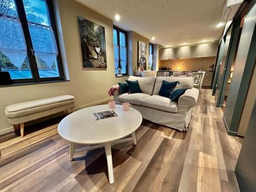 a living room with a couch and a table at Antica Stazione in Guebwiller