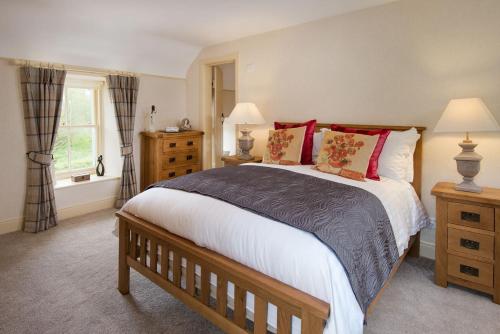 a bedroom with a large bed and a window at Dryburgh Stirling One in Saint Boswells