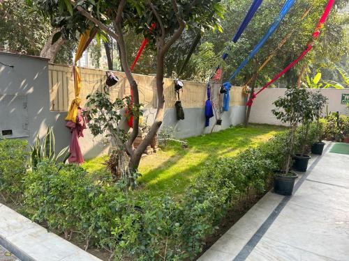 a fence with a tree with prayer flags on it at Sunrise guesthoues in Greater Noida