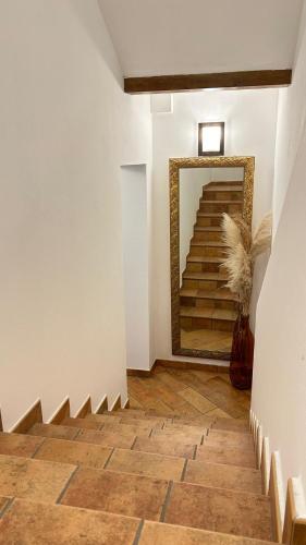 a hallway with a mirror and stairs in a building at Locanda Corte Ruspecchio in Quattro Castella