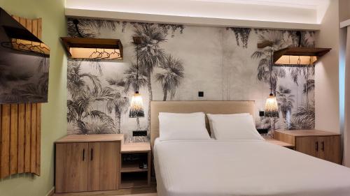 a bedroom with a bed and palm trees wallpaper at Euphoria Apartments Monastiraki in Athens