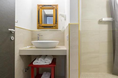 a bathroom with a sink and a mirror at Relais al Porto Suite ORA in Peschiera del Garda