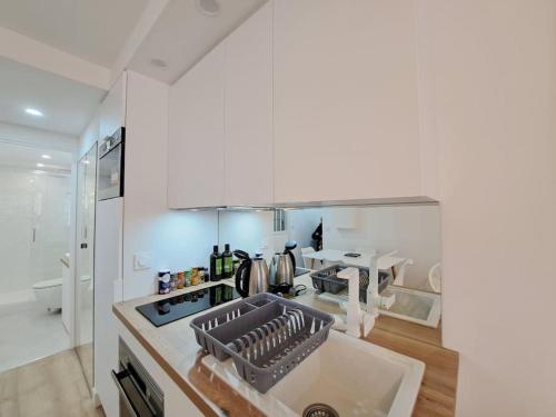 a kitchen with a sink and a counter top at Riga, Appartement Hyper-centre in Reims