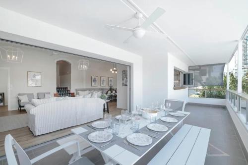 a dining room and living room with a table and chairs at Budds Villa 1 By Khove in Gold Coast