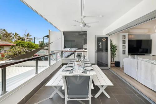 a dining table on the balcony of a house at Budds Villa 1 By Khove in Gold Coast