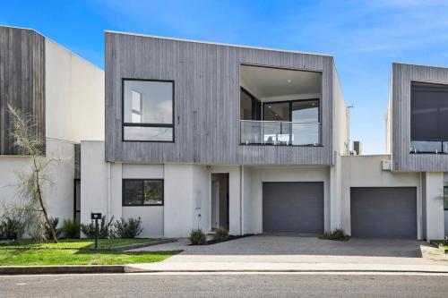 a large white house with a lot of windows at Seaside Style - Modern Coastal Retreat with Ocean Views in Torquay
