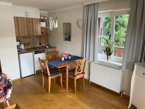 a kitchen with a table and chairs in a room at Wallner am See in St. Wolfgang