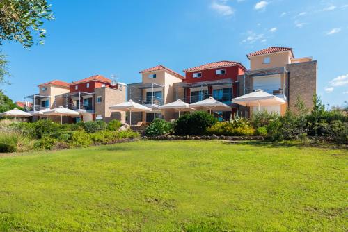 a large house with a lawn in front of it at Dialiskari Villas in Marathopolis