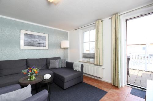 a living room with a couch and a table at Appartementhaus Strandnähe in Warnemünde