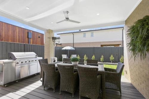 a patio with a table and chairs and a grill at Hampton's Getaway in Torquay in Torquay