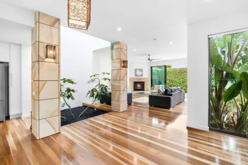 a living room with wood floors and a fireplace at Luxury Torquay Townhouse 150m to Beach in Torquay