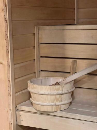 a basket and a wooden spoon on a shelf at Hustadvika Havhotell - by Classic Norway Hotels in Farstad