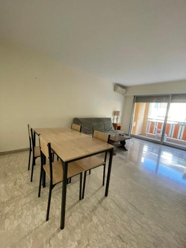 a living room with a table and a couch at GuestRoom - Chambre d'hôte in Le Cannet
