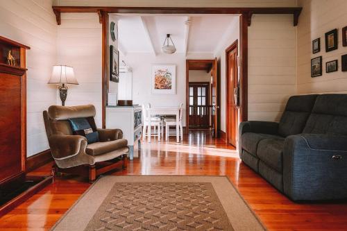 a living room with a couch and a chair at Sunset Cottage By The Bay Pet Friendly in Portarlington