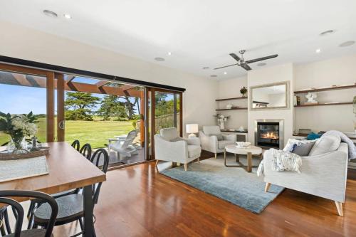a living room filled with furniture and a fireplace at Beach and Golf Haven With Spa Luxury Living in Connewarre