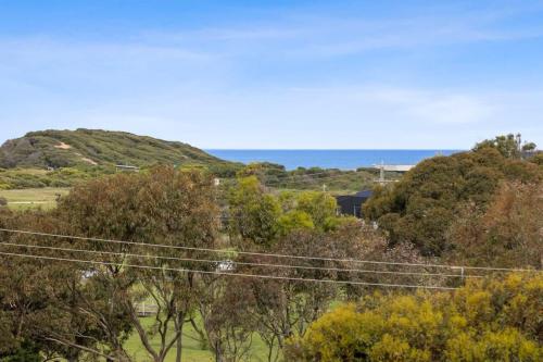 a view of a hill with trees and power lines at Happy Place of Light and Water Views in Jan Juc in Torquay