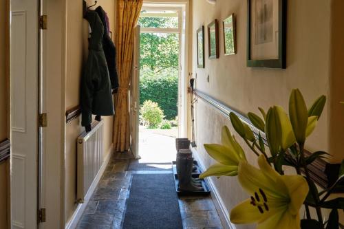 a hallway with a door and a potted plant at Broom House at Egton Bridge in Egton