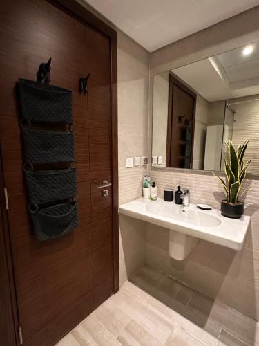 a bathroom with a sink and a mirror at Aura Apartments CFC in Cairo
