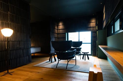 a room with a group of chairs and a table at SHIROIYA HOTEL in Maebashi